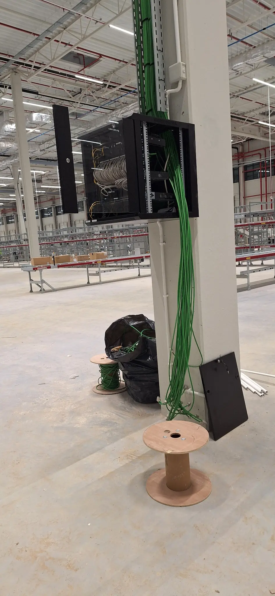 RACK cabinet installation and network cabling preparation in an industrial hall